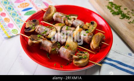 Pork sausage skewer with braised mushrooms. Stock Photo