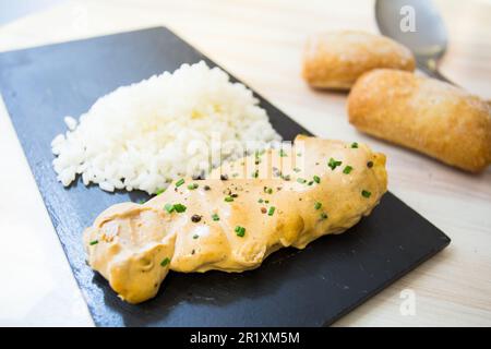 Chicken with curry sauce served with rice. Stock Photo