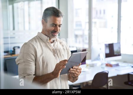 Senior businessman CEO holding digital tablet using fintech tab application. Stock Photo