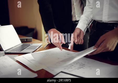 Two engineers pointing at drawings project, Architect team meeting consult and work for architectural construction project working with partner and en Stock Photo
