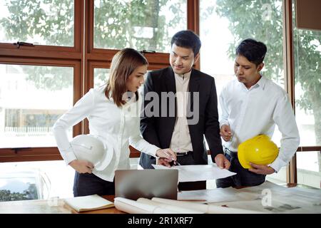 Architect team meeting consult and work for architectural construction project working with partner and engineering after editing on blueprint paper p Stock Photo