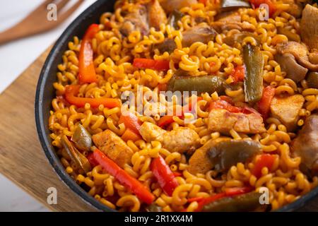 Paella fideua with chicken.Fideuá is a dish originally from Gandía that is  made in a similar way to paella, although based on noodles instead of rice  Stock Photo - Alamy