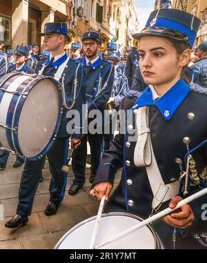 Young woman drummer, Mantzaros marching band performing at street in Campiello (Old Town of Corfu) section, Good Friday procession, Holy Week, town of Corfu, Corfu Island, Greece Stock Photo