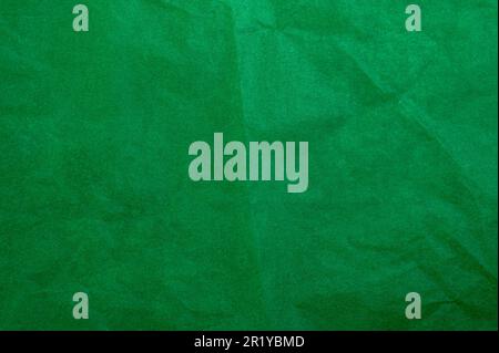 Crumpled dark green tracing paper as texture, holiday backdrop or background, square picture Stock Photo
