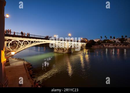 Night view of the Isabel II bridge (Triana Bridge) at Sunset, Sevilla, Spain, Europe,. Stock Photo