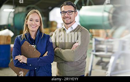 You can depend on us. Portrait of a two smiling managers standing on the warehouse floor. Stock Photo