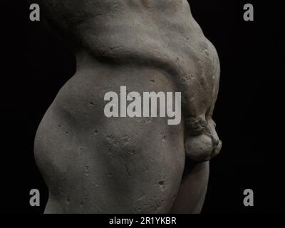 Ancient statue of Priapus symbol of the fertility of ancient Rome isolated on blACk BACKGROUND Stock Photo