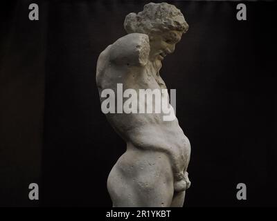 Ancient statue of Priapus symbol of the fertility of ancient Rome isolated on blACk BACKGROUND Stock Photo
