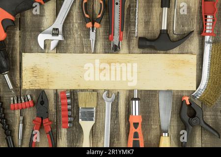 Construction equipment, layout of construction tools. Repair equipment on a carpentry wooden table. Frame composition with copy space, top view Stock Photo
