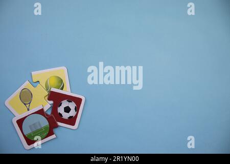 Information puzzles placed on the edge of the blue background. Tennis, football. Stock Photo