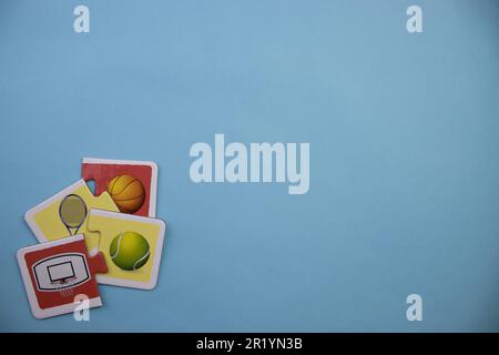 Information puzzles placed on the edge of the blue background. Tennis, basketball. Stock Photo