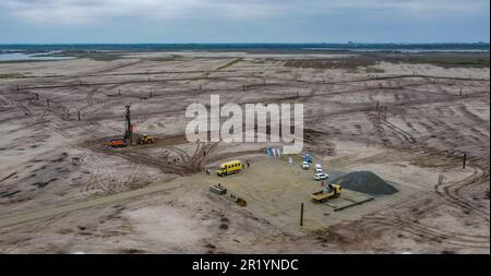 Cottbus, Germany. 16th May, 2023. View of the huge construction site for a floating photovoltaic plant on the site of the future Ostsee (aerial view taken by drone). The floating 29 MWp solar plant on the future Cottbus Baltic Sea will, according to its own specifications, be one of the largest floating PV plants in Europe when completed and will make a decisive contribution to the energy supply of the climate-neutral harbor quarter planned by the city of Cottbus. Credit: Patrick Pleul/dpa/Alamy Live News Stock Photo