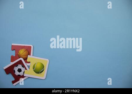 Information puzzles placed on the edge of the blue background. Sports balls. Stock Photo