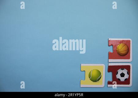 Information puzzles placed on the edge of the blue background. Sports balls. Stock Photo