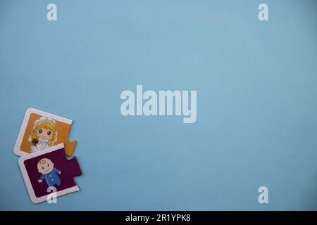 Information puzzle placed on the edge of the blue background. Baby and mom. Stock Photo