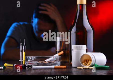 Addictive substances and the figure of a addicted man Stock Photo