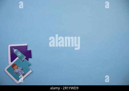 Information puzzle placed on the edge of the blue background. Astronaut, toothpaste Stock Photo