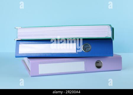Stack of office folders on light blue background Stock Photo
