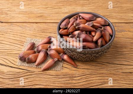 Pinions or pine tree seeds on a bowl over wooden table. Stock Photo