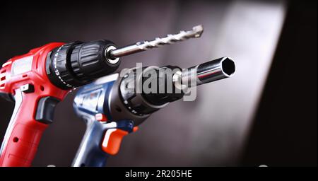 A pistol-grip cordless drill and a screw gun Stock Photo