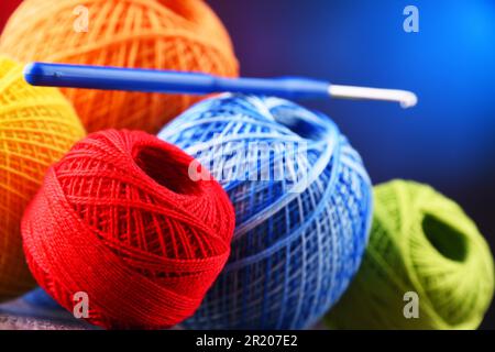 Composition with assortment of different colored yarns and hook for crocheting Stock Photo