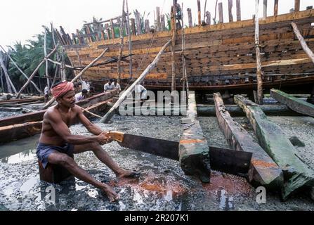 A Carpenter in the process of making traditional wooden cargo boat at Cuddalore, Tamil Nadu, South India, India, Asia Stock Photo