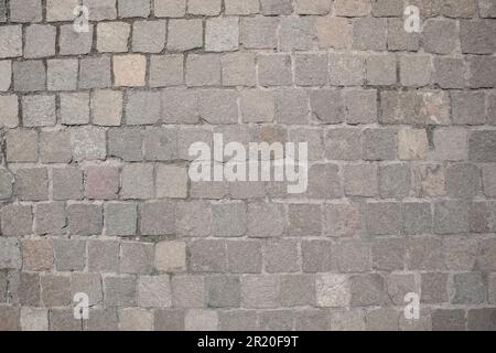 Stone pavement background. Natural natural material stone laid on the square Stock Photo