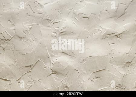 The uneven surface of a beige clay wall Stock Photo