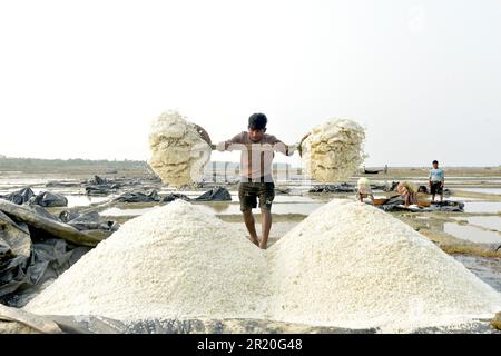 Cox's Bazar. 16th May, 2023. People work at a salt farm in Cox's Bazar, Bangladesh on May 15, 2023. Farmers in Bangladesh's Cox's Bazar district, some 300 km southeast of capital Dhaka, are now busy harvesting salt after cyclone Mocha hit the lands. Credit: Xinhua/Alamy Live News Stock Photo