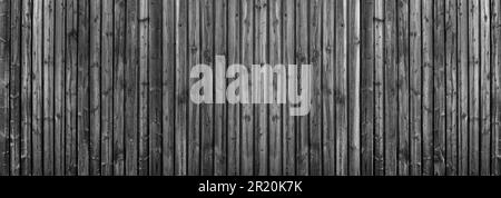 Dark grey wooden wall made of vertical planks with intense wood grain Stock Photo