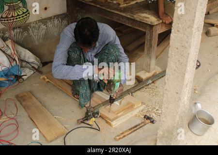 Close up Carpenter busy working - concept of artisans, self employed and skilled labour, India, Odisha Stock Photo