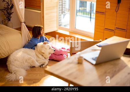 Woman with dog relaxing at home Stock Photo