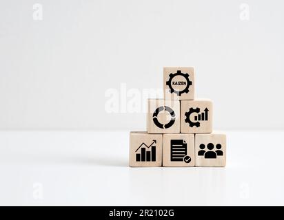 Kaizen concept. Continuous improvement of quality, efficiency and effectiveness in business. Kaizen symbols on wood cubes. Stock Photo