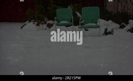 Graphic resource Holiday winter greeting of empty green vintage retro lawn chairs covered in snow Stock Photo