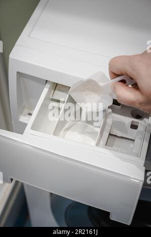 Blue plastic washing powder measuring cup isolated on white Stock Photo -  Alamy