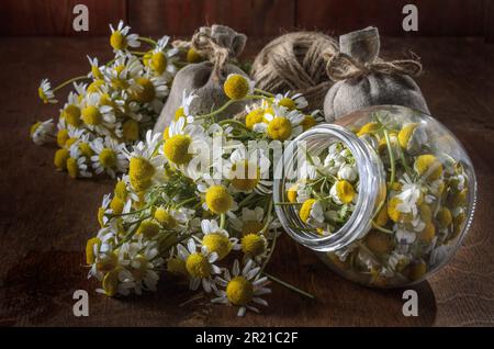 Medicinal herbs in burlap bags on an old wooden background, herbal medicine. Stock Photo