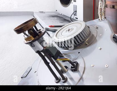 Technical picture on the subject of oil heating. In the boiler room, the heating engineer opened the oil burner to clean and inspect it. In the foregr Stock Photo