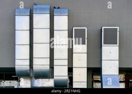 Galvanized tin square ventilation system pipeworks on a gray wall background Stock Photo