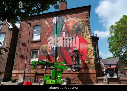 Liverpool, UK. 16th May, 2023. Artist Paul Curtis puts finishing touches to a new wall art of the Liverpool FC Women's player Missy Bo Kearns in Tancred Road, Liverpool. A scouser and lifelong Red, Kearns has been on the club's books since the age of eight and has successfully progressed through the ranks with Liverpool while also being capped by England at U23 level. Credit: SOPA Images Limited/Alamy Live News Stock Photo