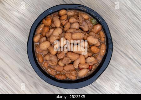 Overhead view of side order of whole pinto beans, slow cooked to perfect softness and served in decorative bowl. Stock Photo