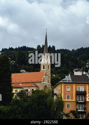 Brick wall catholic church Saint Nicholas (Nikolaus) in Innsbruck, Tyrol, Austria, cloudy sky summer Stock Photo