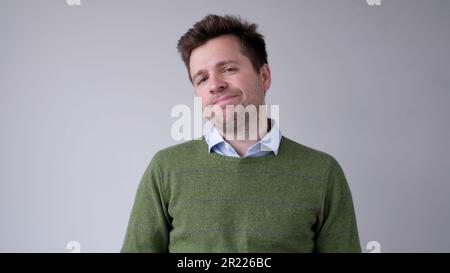 European, young man, shakes his head in disbelief and looks skeptically into the camera Stock Photo