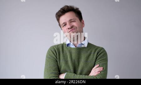 European, young man, shakes his head in disbelief and looks skeptically into the camera Stock Photo