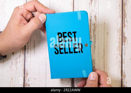 The word Best Seller is written in black marker on the yellow paper for notes. Stock Photo