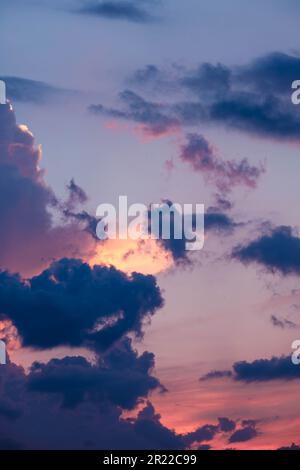 Intense pinks and blues in evening sky with glowing cloudscape Stock Photo