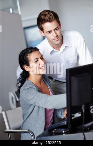Coworkers pooling their expertise. Two young designers collaborating on a project together. Stock Photo