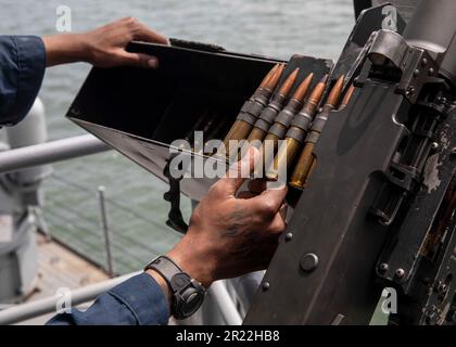 230515-N-SK738-1077 ATLANTIC OCEAN (May 15, 2023) Aviation Ordnanceman Airman Erskine Moore, assigned to the Nimitz-class aircraft carrier USS George H.W. Bush (CVN 77), loads bullets into a .50-caliber gun, May 15, 2023. George H.W. Bush provides the national command authority flexible, tailorable war fighting capability through the carrier strike group that maintains maritime stability and security in order to ensure access, deter aggression and defend U.S., allied and partner interests. (U.S. Navy photo by Mass Communication Specialist Seaman Apprentice Pierce Luck) Stock Photo