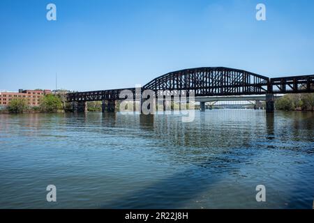 A railroad bridge and other crossings span the Allegheny River under a sunny sky in Pittsburgh. Stock Photo