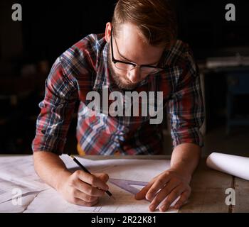 Turning his vision into reality. An architect drawing up plans. Stock Photo