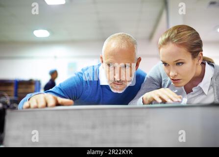 I like your precision. Two publishers assessing the quality of printed work in a factory. Stock Photo